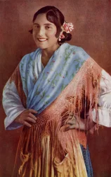 Spanish Señorita with bright eyes and enchanting smile in a typical dress